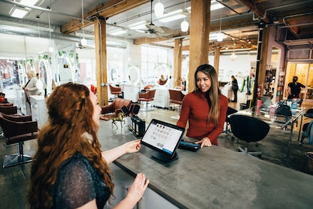 woman using pos system in shop