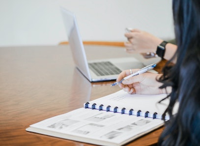 person using quickbooks on laptop